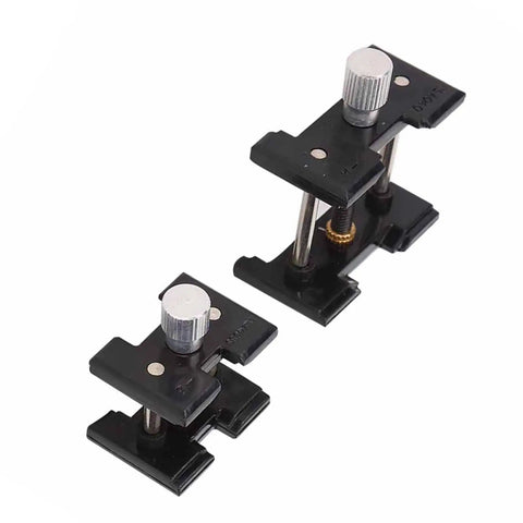 Two Piece Watch Movement Holder Kit With Non Slip Fixed Base and Plastic Repair Tool in black, side by side on white background.