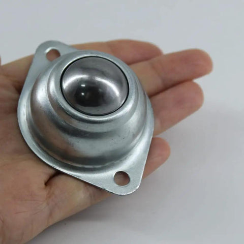 One Inch Flange Mount Ball Transfer Bearing held in hand, showcasing its durable carbon steel build, ideal for smooth conveyor setup.