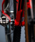 Single Sensing MTB Power Meter Pedal For Left Side, 100 Percent SPD Compatible, Bluetooth ANT Plus on red bike close-up