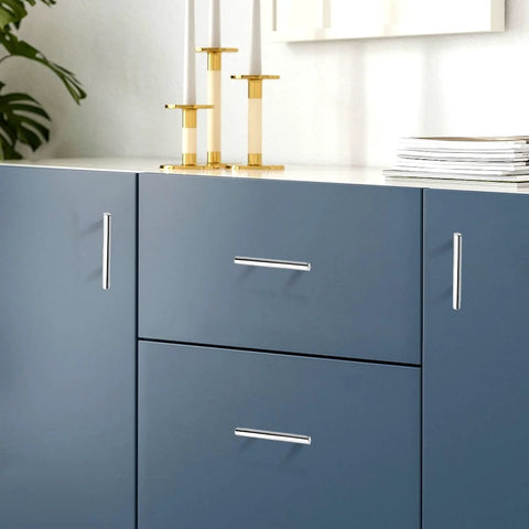 Close-up of polished chrome T bar cabinet pulls 256mm hole centers 10 inch center to center on blue kitchen cabinets
