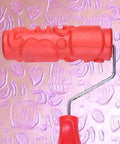 Killer DIY Doodle Dinosaur Wall Printing Roller with High Density Microfiber Cover, red roller tool against pink embossed wall.