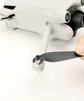 Installing Low Noise Quick Release Propeller Set For Mini 4 Pro And Mini 3 Pro Replacement Blades on drone motor.