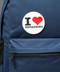 Outdoor Adventure Pin Set Five Pack Two And A Quarter Inch Round Metal Badges For Geocaching Fans on a blue backpack.