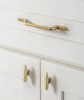 Six Pack Champagne Bronze Cabinet Knobs And 2.2 Inch Modern Gold Bar Pulls on white kitchen dresser