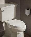 Brevia Slow Close Elongated Toilet Seat With Grip Tight Bumpers And Quick Attach Hardware Biscuit Color installed in bathroom