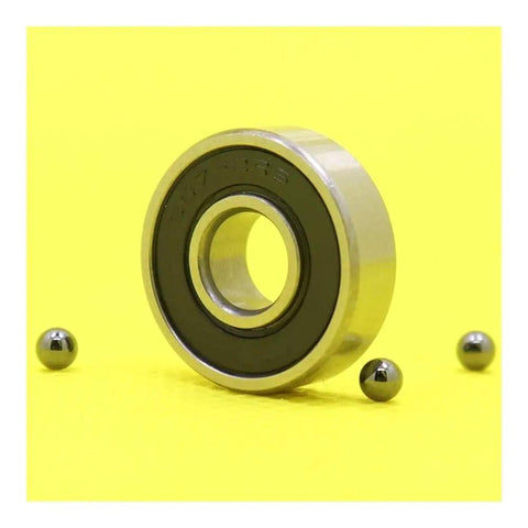 Heavy Duty 607 Hybrid Ceramic Ball Bearings With Si3N4 Balls And Steel Rings For High Speed Motor Spindles And Industrial Machines ABEC-1 Precision Smooth Running Setup on yellow background with steel balls.