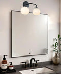 Double Glass Globe Wall Sconce, 17 Inch Sleek Modern Design in matte black above mirror in bathroom with vanity sink