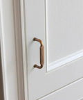 Close-up of Antique Brass Zinc Alloy Cabinet Pulls 12 Pack Three And Three Quarters Inch Hole Centers Drawer Handles for kitchen cabinets.