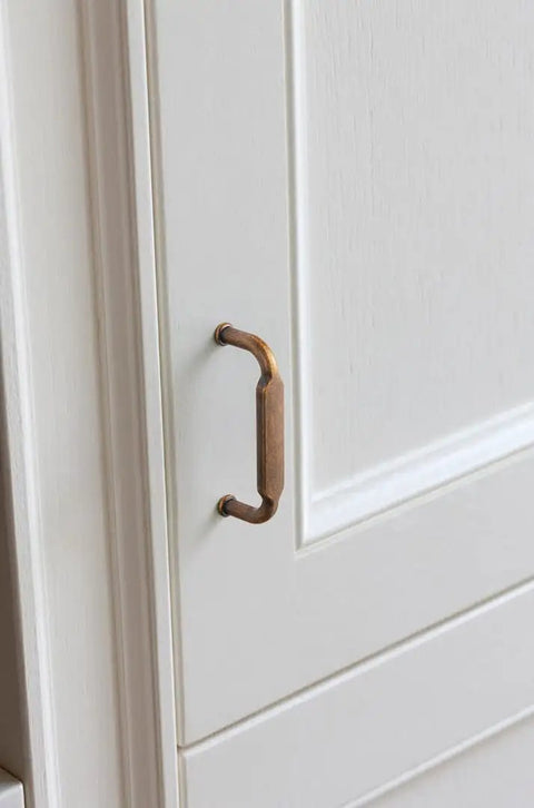 Close-up of Six Pack Dark Champagne Bronze Zinc Alloy Cabinet Pulls With Twelve Point Six Inch Hole Center Spacing And Thirteen Point Zero Five Inch Overall Length Kitchen Drawer Handles That Look Dope Includes M Four Screws Durable Contemporary Pulls on white cabinet
