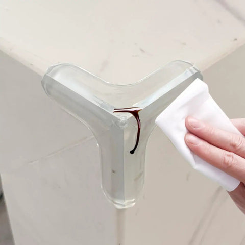 Triangular PVC Corner Protectors Set Of 10 With Corner Brace Design for desktops being wiped clean by a hand.