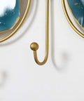 Close-up of gold hook from Wall Mounted Coat Rack With Heavy Duty Iron Hooks For Entryway Or Bathroom Door Organizer.