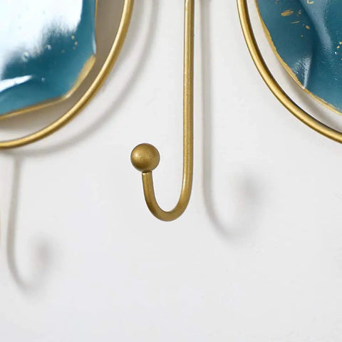 Close-up of gold hook from Wall Mounted Coat Rack With Heavy Duty Iron Hooks For Entryway Or Bathroom Door Organizer.