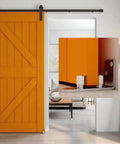 Adjustable Floor Guide For Sliding Barn Doors, Wall And Door Bottom Roller, shown in stainless steel with quiet operation on an orange barn door