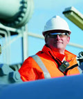 Worker wearing safety gear with ALTAIR 2X Single Gas Detector For Carbon Monoxide CO 25 To 100 PPM in industrial setting