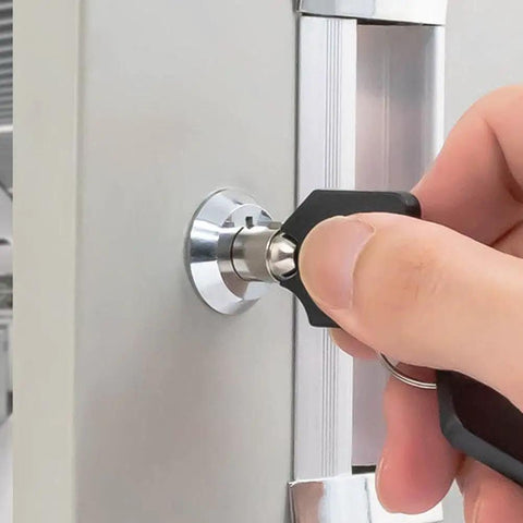 Universal Tubular Lock Set For Toolboxes Cabinets Drawers And Furniture With Keys Durable Metal Construction Secure Reliable Locking System Replacement Hardware Easy Install For Home Organization And Security. Metal tubular lock installed on a gray cabinet door with key inserted