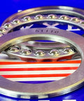 Close-up of 51110 Thrust Bearing 50x70x14mm showing chrome steel rings and ball bearings on a blue-striped background.