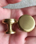4 Piece Mid Century Modern Solid Brass Cabinet Knob Set For Drawers And Jewelry Boxes single hole pulls shown in hand
