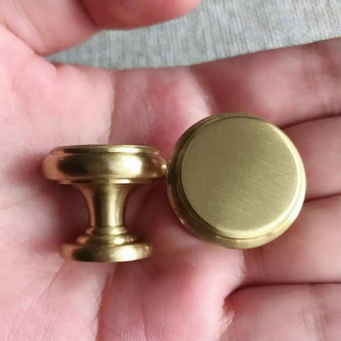 4 Piece Mid Century Modern Solid Brass Cabinet Knob Set For Drawers And Jewelry Boxes single hole pulls shown in hand