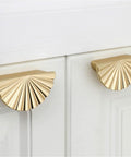 Semicircle Sunflower Cabinet Pulls In Brushed Gold Finish 6 Pack installed on white cabinets