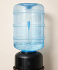 5 Gallon BPA Free Water Bottle Reusable Jug With Large Capacity Polycarbonate Container Universal Top Load And Bottom Load Dispenser Compatibility For Home And Office Use on a dispenser.