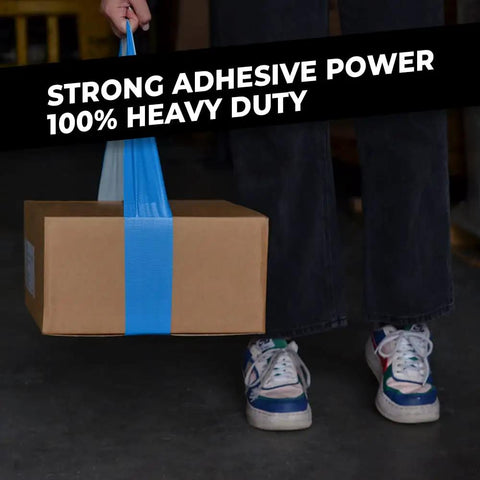 Person holding a cardboard box wrapped with blue heavy-duty tape, emphasizing strong adhesive and durability.