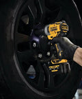 12V Max 3/8 Inch Cordless Impact Wrench Kit in use tightening a wheel lug on a black tire, showcasing portability and precision.