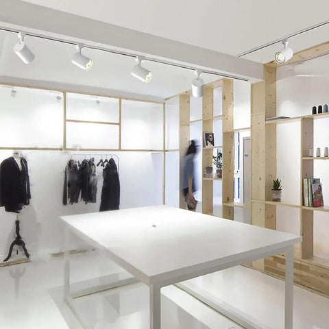 Modern showroom with Dope 15W H Type LED Track Light Heads for accent lighting and artwork, 3000K warm white halo style lights installed.