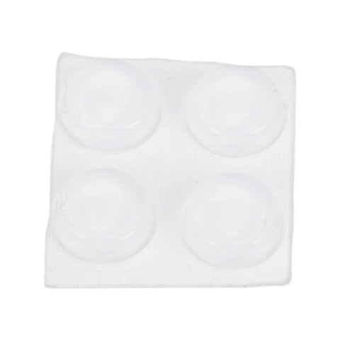 Close-up view of a white rubber pad with four round adhesive bumpers for protecting surfaces.
