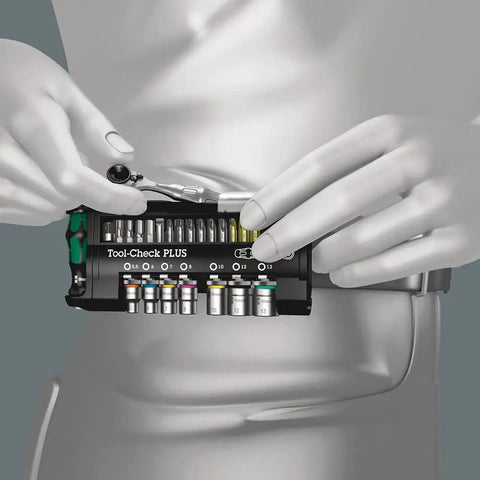 Person holding Tool Check Plus Imperial 39 Piece Bit And Socket Set with color coding, showcasing compact design and hex drive