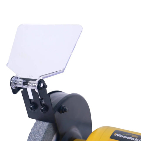 Close-up of high-speed bench grinder with protective shield, part of the High Speed Bench Grinder And Belt Sander Combo With Two Point Five Amp Motor 6 Inch Grinder And Two 27 Inch Belts For Metal Grinding And Wood Sanding A Versatile Two In One Home Workshop Tool For DIY Projects.