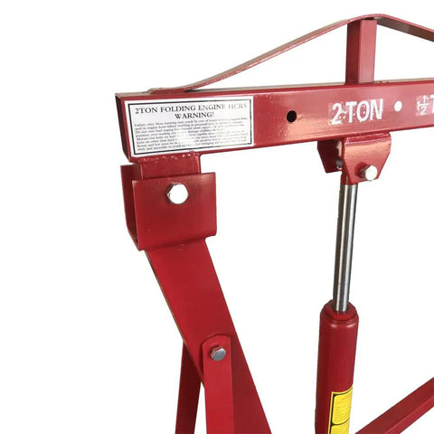 Detail of 2 Ton Folding Engine Hoist And Heavy Duty Engine Crane with warning label and lifting arm.
