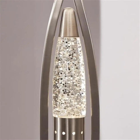 Close-up of Ultra Modern Table Lamp With Sparkling Water Droplet Dance Night Light, Satin Nickel Finish, glass and metal frame.