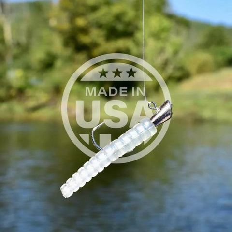 Close-up of neon grub lure with hook and float in fishing kit, part of 142-Piece Trout Fishing Gear Kit With Neon Grub Lures, 20 Hooks And 2 Floats, High-Grade Freshwater And Saltwater Tackle Set For Pros And Serious Anglers Who Want Easy, Consistent Bites, with USA label.