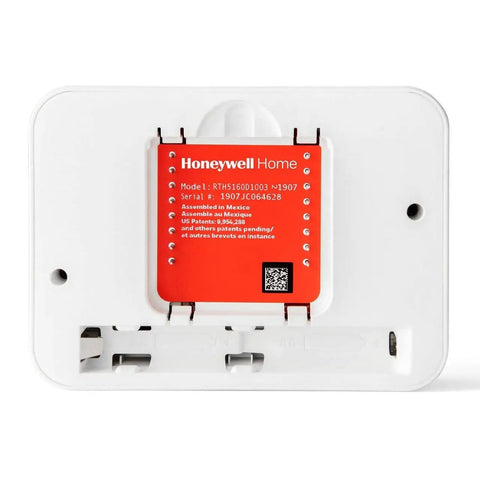Back view of Renewed Non Programmable Thermostat With Simple Single Degree Control and battery compartment exposed.