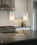 Dual Glass Pendant Lights 2 Pack with Brushed Nickel Finish hanging above a kitchen island with clear and frosted glass shades.