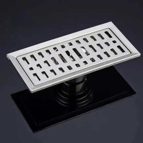 Premium Stainless Steel Rectangular Floor Drain For Bathroom With Massive Flow Deodorant Hair Catcher Slick Shower Grate With Durable Top Tier Light Grey Build viewed on dark surface with visible drainage slot.