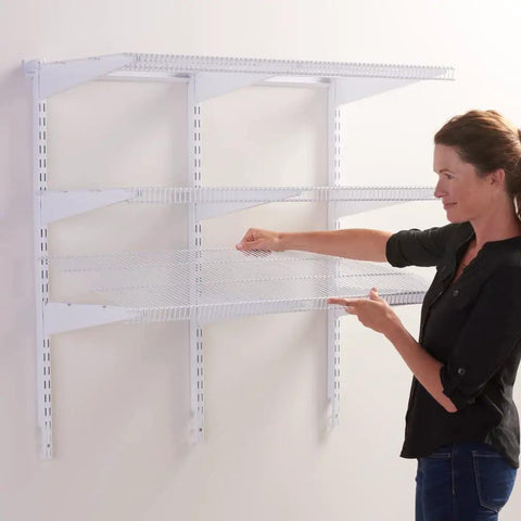 Woman adjusting 36 Inch Pantry Shelf System With Direct Wall Mount, 4 White Wire Shelves And Mounting Hardware Included on wall.