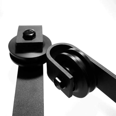 Close-up of Hella Sturdy 7.5ft Sliding Barn Door Hardware Kit smooth gliding track system showing matte black steel rollers.