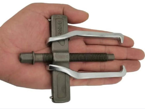 2 Jaw Gear Puller For Pulley Flywheel And Bearing Removal Pro Grade Gear Puller For Auto Shop Use Easy Bearing Extraction Small Gear Puller Tool 4 Inch Capacity Heavy Duty Auto Shop Puller With Dual Claw Design displayed in hand