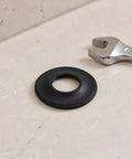 10pcs Rubber Bathtub Drain Washer for Pop up Stoppers and Drains, close-up of a rubber gasket on a counter with a wrench.