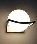 Solid Metal Wall Sconce With Glass Housing Delivers Hella Bright Ambient Glow Perfect For Indoor And Outdoor Decor mounted on wall.