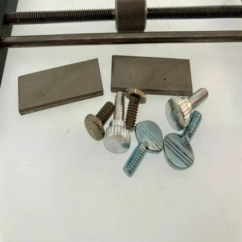 Pro Grade Clock Repair Tool Set With Plate Spreader And Pivot Tool Hardware displaying metal plates and screws