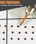 Diamond tile drill bit on white ceramic tile; orange bit with hex shank for dry drilling.