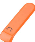 Orange handle of a tool with markings, showing direction indicators, designed for easy grip and control.