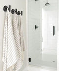 Large Suction Cup Shower Hooks Set Of 2 Black Stainless Steel Towel Hooks holding striped towels inside a shower