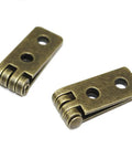 Pro Grade Antique Bronze Folding Butt Hinges With Matching Screws For Doors Cabinets And Jewelry Boxes Straight Up Durable Zinc Alloy Vintage Hardware Slick Swing - close-up view of two metal hinges.