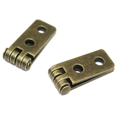 Pro Grade Antique Bronze Folding Butt Hinges With Matching Screws For Doors Cabinets And Jewelry Boxes Straight Up Durable Zinc Alloy Vintage Hardware Slick Swing - close-up view of two metal hinges.