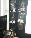Beefy Ski And Snowboard Wall Mount Storage Rack invisible floating display showcasing two boards with bindings mounted on a dark wall.