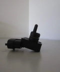 Hyundai MAP Sensor Assembly 39300-2B100 Black OEM Quality Direct Fit For Your Ride, Clean Drop-In Replacement That Keeps Your Engine Running Smooth With Accurate Readings And Real-Deal Reliability black plastic sensor side view