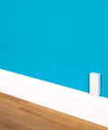 Ultra Flat Adhesive Speaker Wire 16 AWG 2 Conductor, 50 Ft White Spool on blue wall, Ghost Wire 2.0, paint-friendly installation